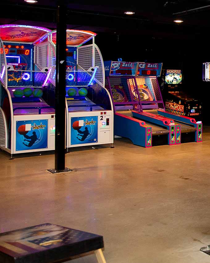 Arcade games lined up in a row. Montana Nights event space. Montana Nights Top Axe-Bar + Entertainment Center in CT