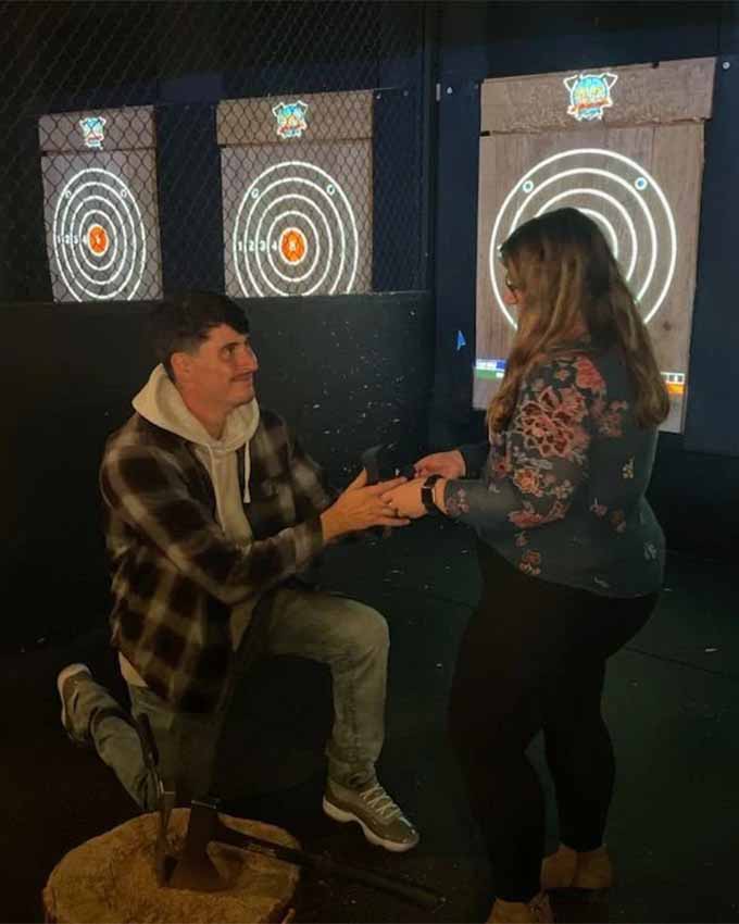 Man proposing in the axe throwing cages. Montana Nights event space. Montana Nights Top Axe-Bar + Entertainment Center in CT