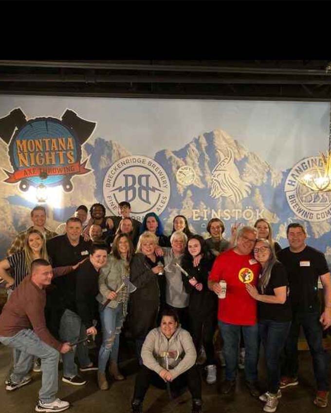 Team Photo in front of glacier mural. Montana Nights Top Axe-Bar + Entertainment Center in CT