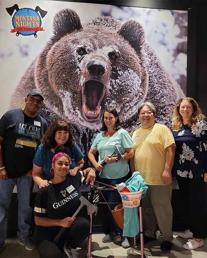Health group photo in front of bear. Montana Nights Top Axe-Bar + Entertainment Center in CT