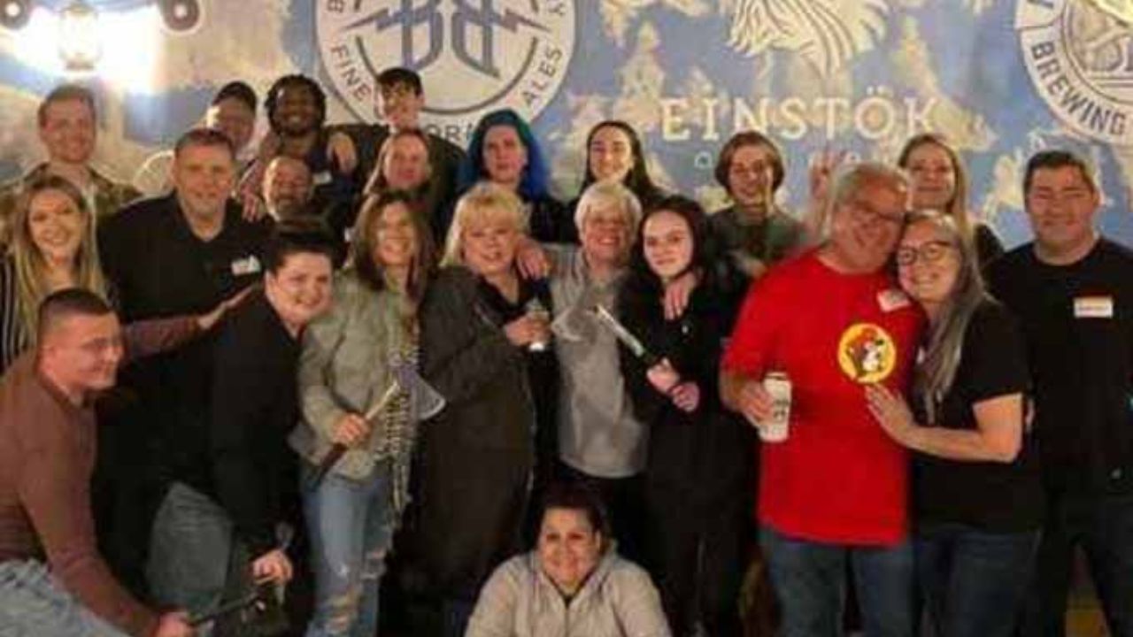 Group of guests posing together at Montana Nights axe throwing venue.