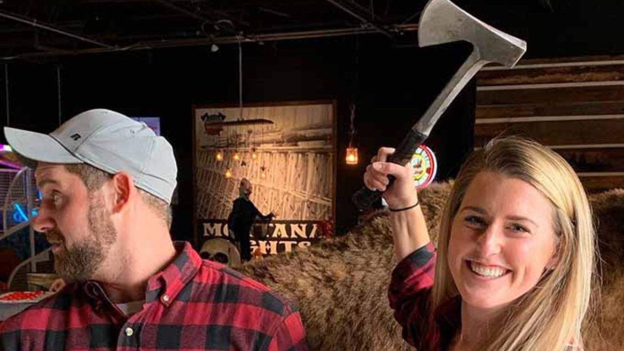 Couple enjoying hatchet throwing game at Montana Nights venue