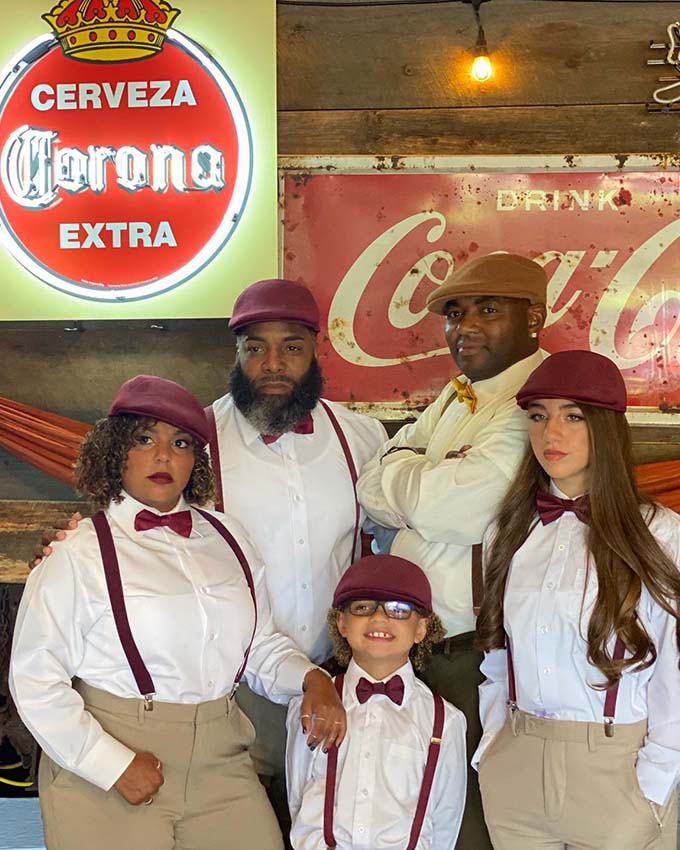 Family dressed in coordinated vintage outfits for a themed event at Montana Nights Axe Throwing.