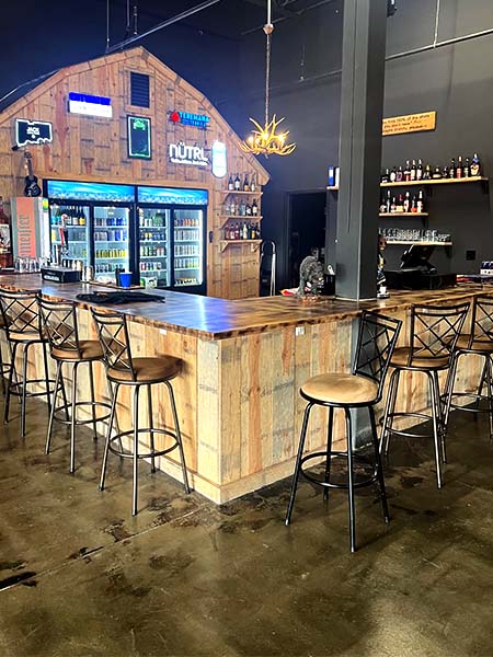 Modern axe throwing bar in Putnam with rustic wood counter and drink station interior
