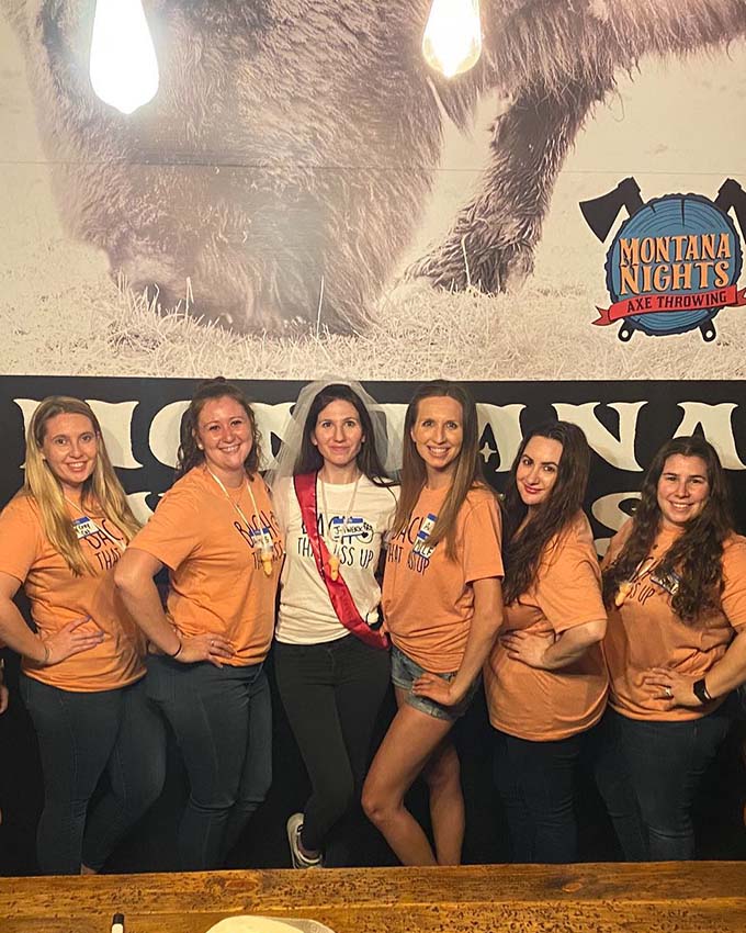 Bachelorette party group posing together before an axe throwing celebration at Montana Nights.