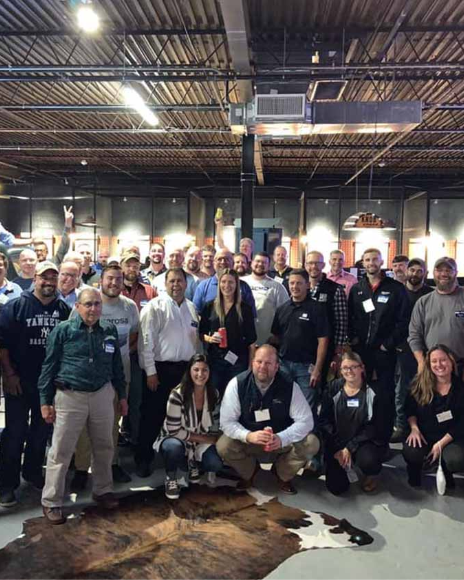 Group of coworkers posing together at a retirement party.