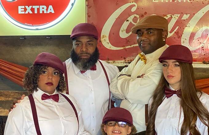 Guests dressed in coordinated vintage outfits during a themed private party at Montana Nights Axe Throwing.