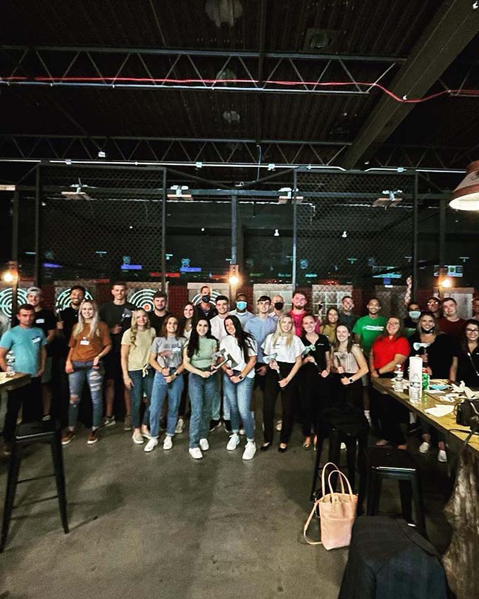 Large group posing together after an axe throwing event at Montana Nights.