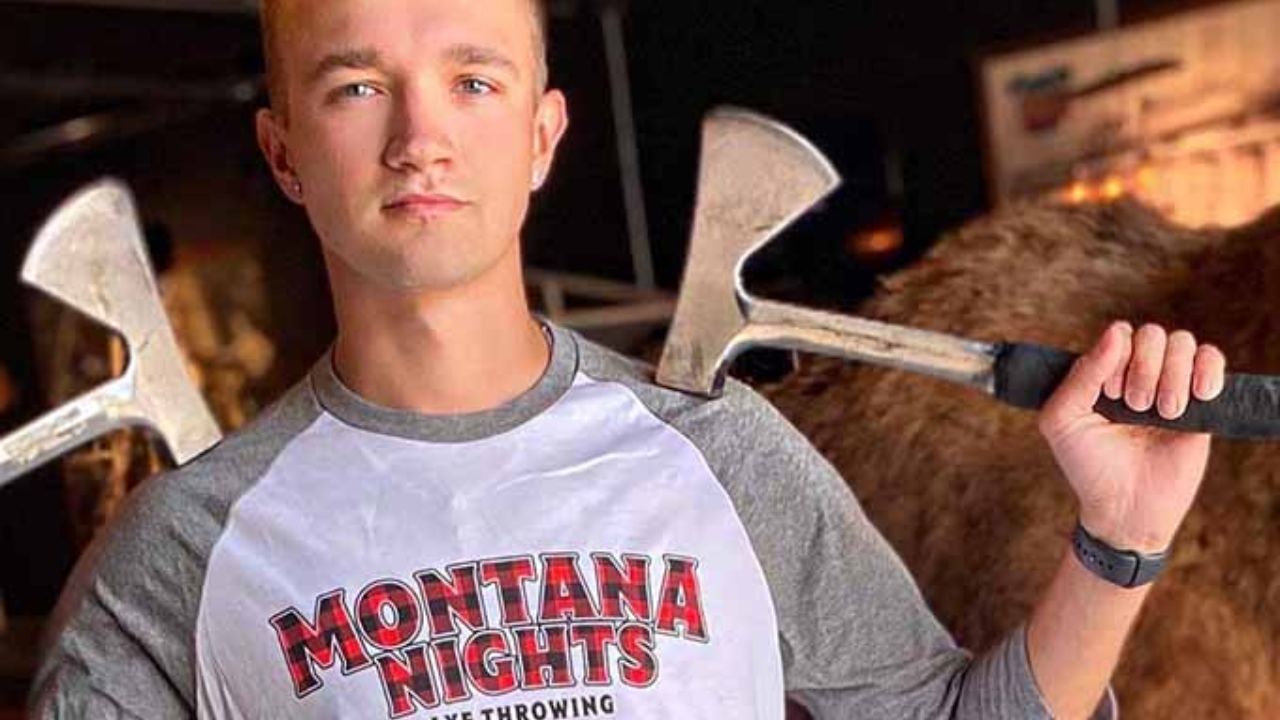 Axe throwing participant holding an axe at Montana Nights.
