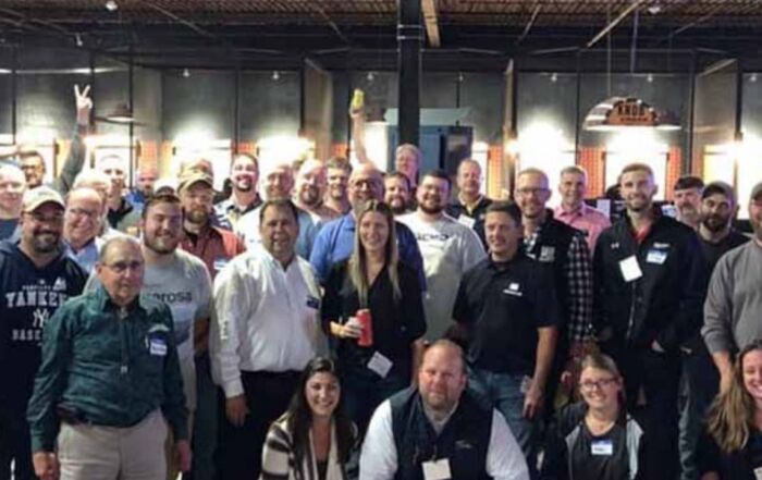 Large group gathering for a fun corporate team-building event at an indoor venue.