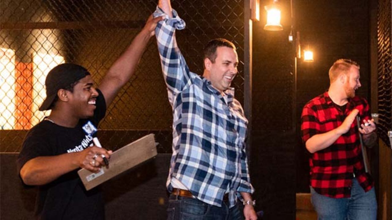 Friends celebrating a successful axe throw during a group event.