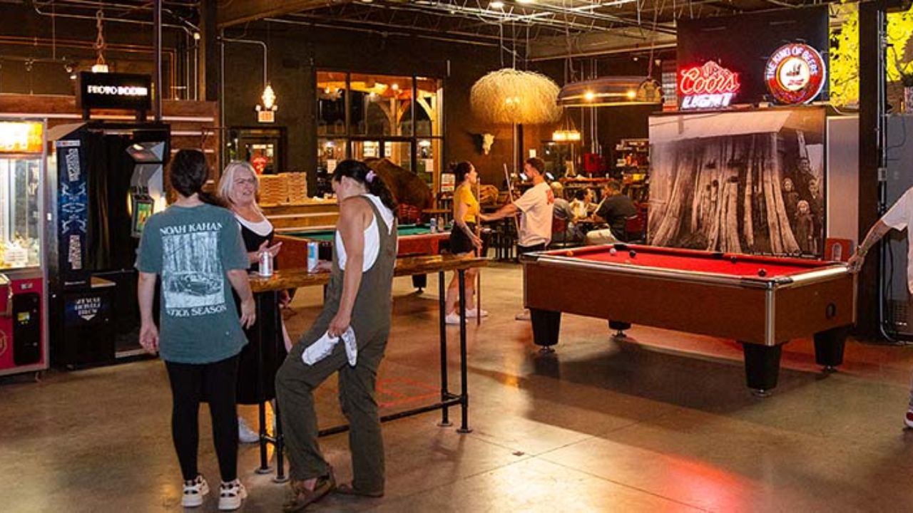 Guests enjoying arcade games, pool tables, and social activities indoors at Montana Nights.