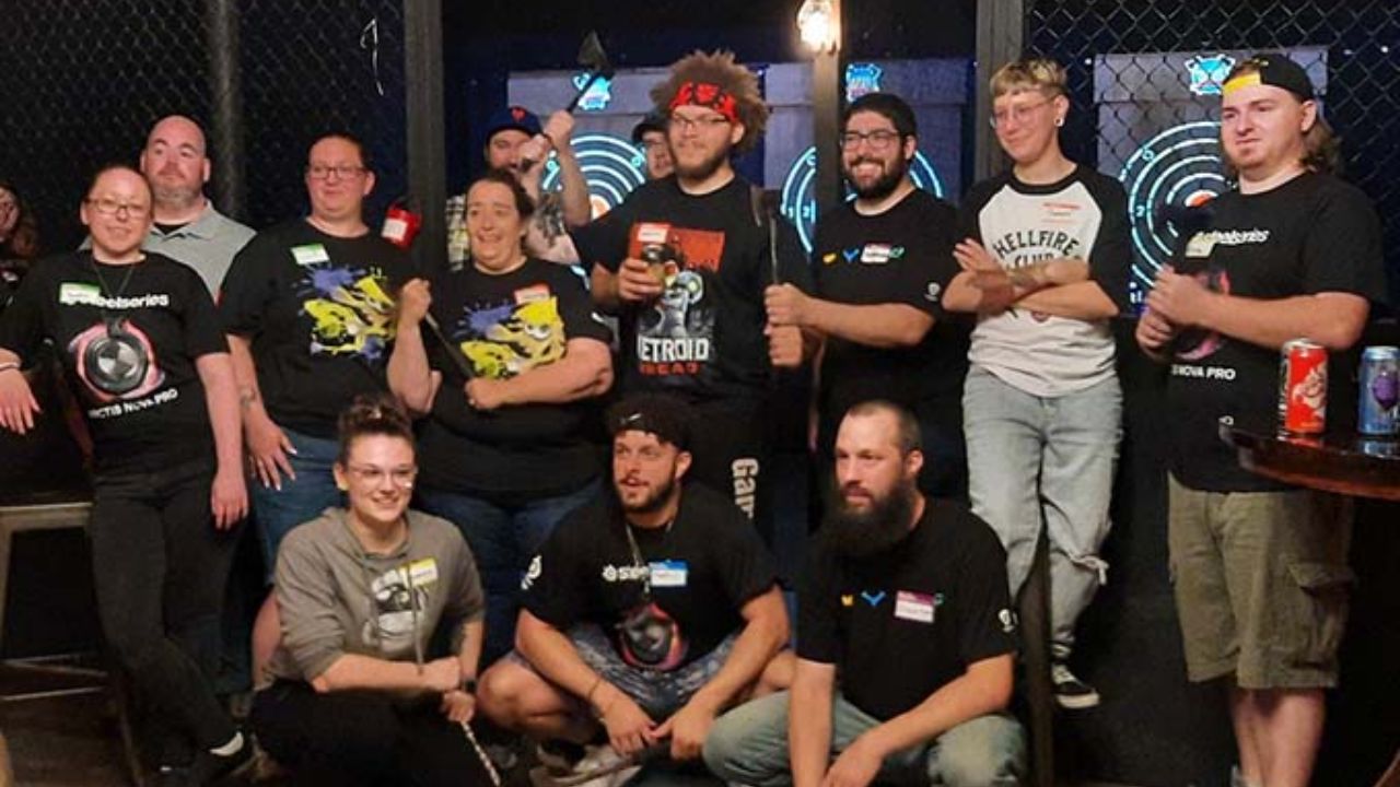 Group enjoying a fun team-building event at an indoor axe throwing venue.