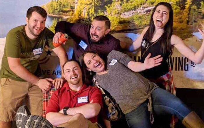 Friends enjoying a fun group outing at an indoor axe-throwing venue.