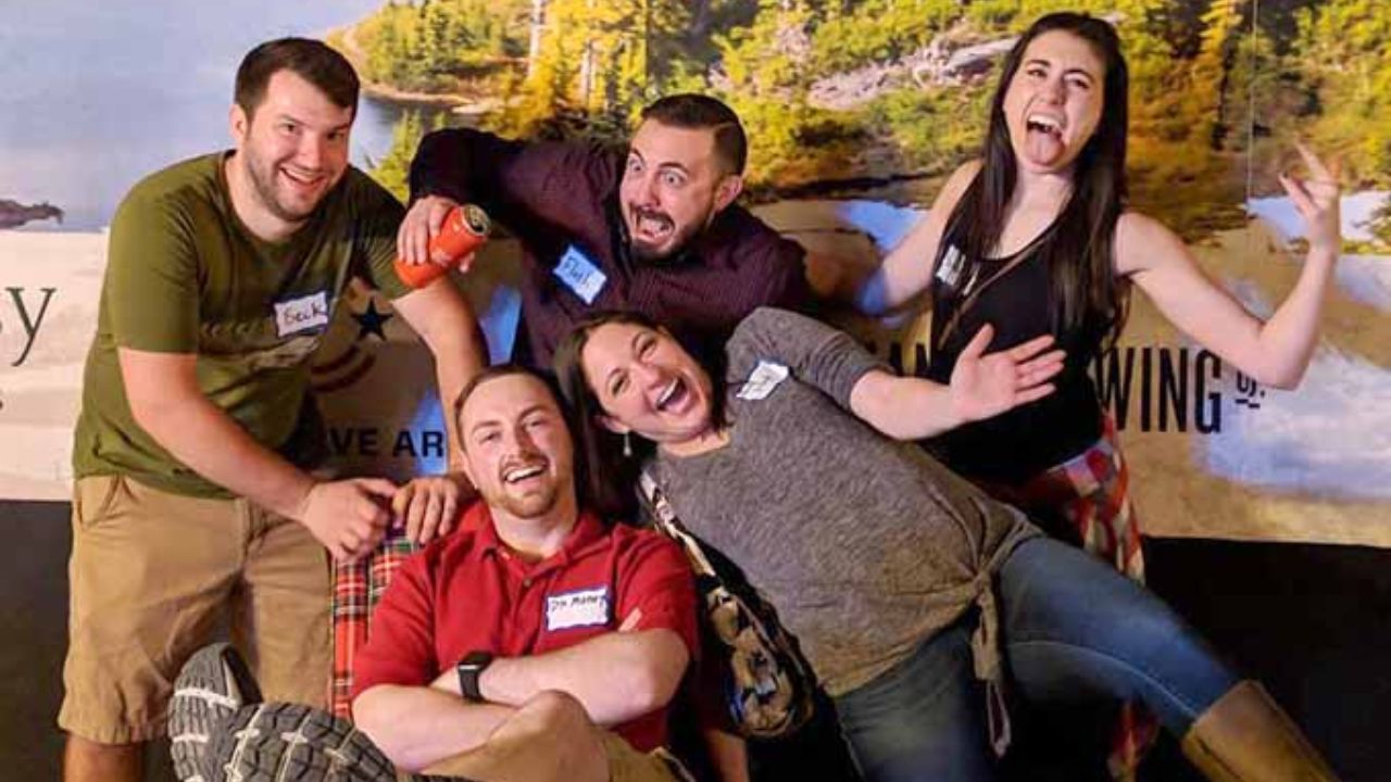 Friends enjoying a fun group outing at an indoor axe-throwing venue.