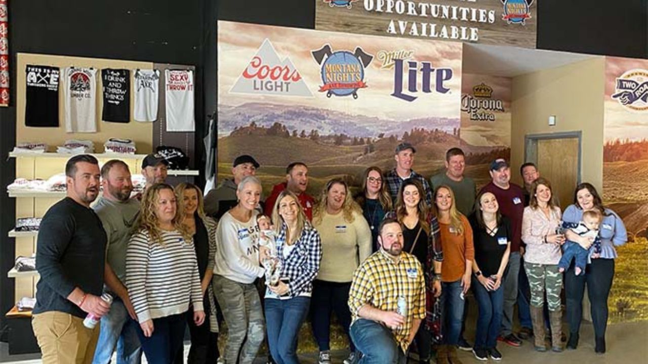 Friends and family pose for a group photo at Montana Nights Axe Throwing.
